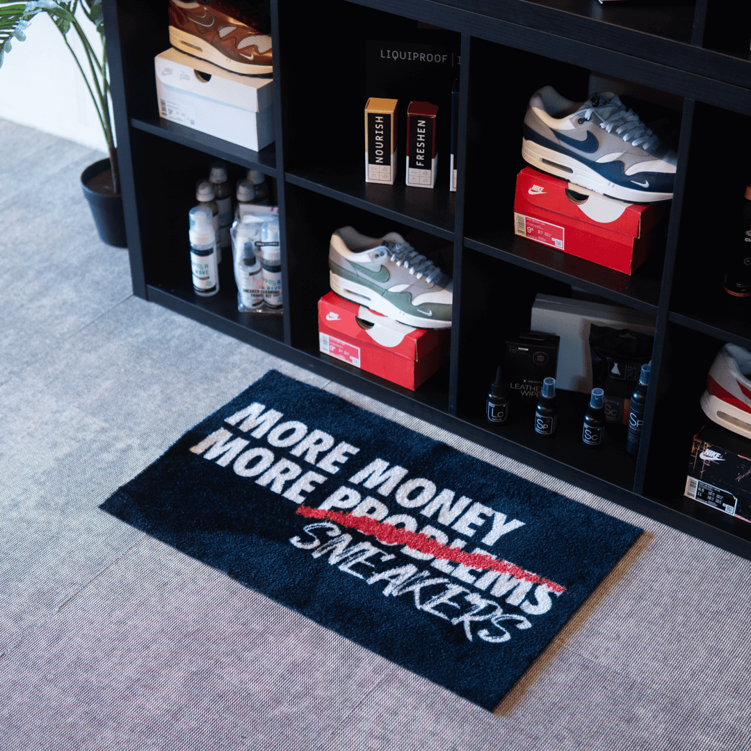 a shoe rack with shoes and a rug
